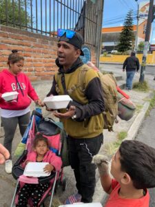 Amigos en Accion providing meals to a migrant family in La Luz neighborhood of Quito